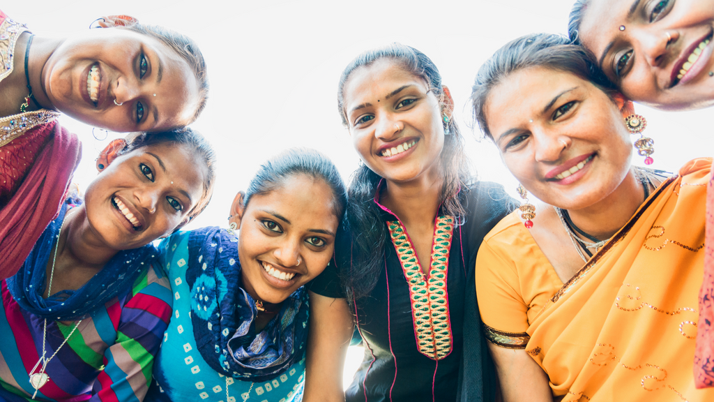 A confident group of women stands together, showcasing their strength and unity 