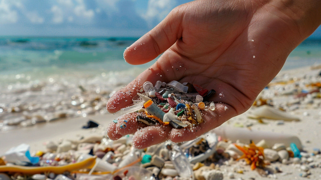 Hand holding microplastic debris collected from a polluted beach.